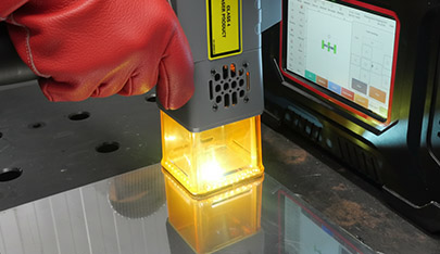 An image of the handheld laser engraver in action
