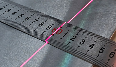 An image of a metal ruler being engraved