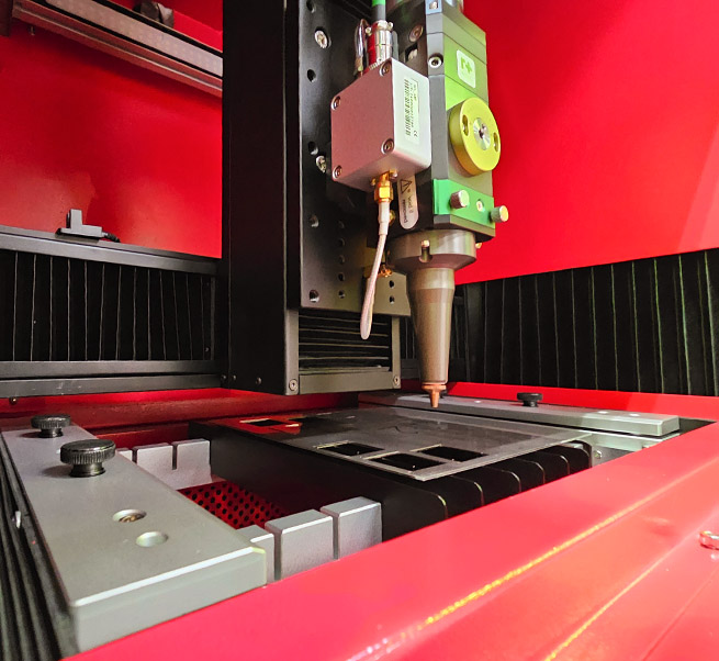 A close up image of the HPC desktop fibre laser cutter.