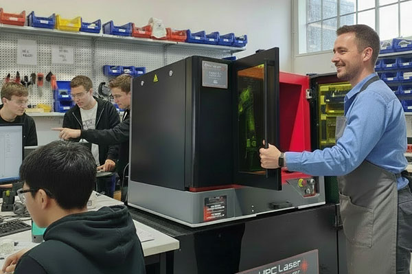 An image of a teacher using the HPC desktop fibre laser cutter