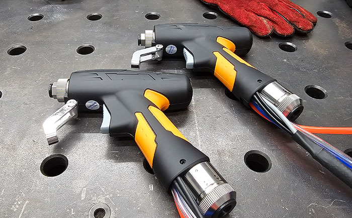 An image of multiple HPC laser welding guns on a desk